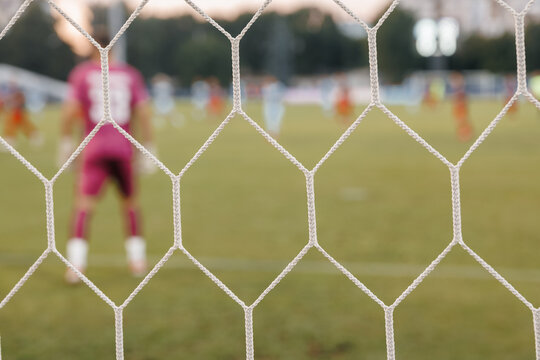 Football net detail close-up, soccer goal mesh on green grass field and sports competition concept