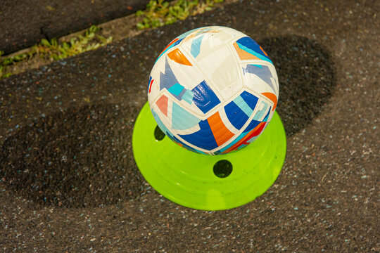 Official match ball sitting on display stand on sideline, football sports competition and game kickoff concept