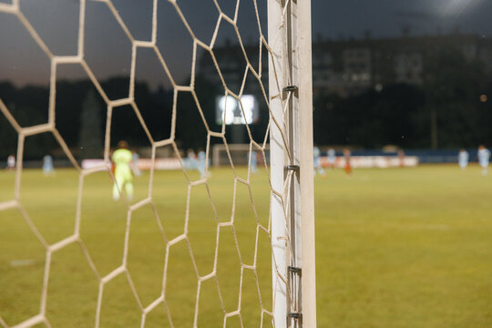 Football net detail close-up, soccer goal mesh on green grass field and sports competition concept
