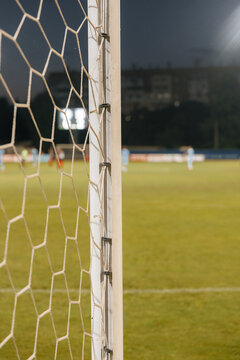Football net detail close-up, soccer goal mesh on green grass field and sports competition concept