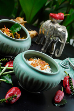 Cambodian coconut soup and rice in ceramic bowl with chili