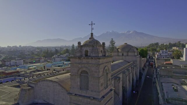 Aerial view of the historic Arequipa Cathedral with its stone facade and bell tower set against the backdrop of the Misti volcano in Arequipa, Arequipa, Peru.