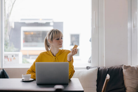 Blond woman doing online payment with her credit card