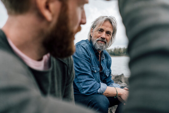 Father and son meeting at Rhine river in autmn, talking together