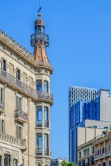 Modernist Building Turret and Modern Glass Skyscraper, Barcelona, Urban Contrast © ikuday