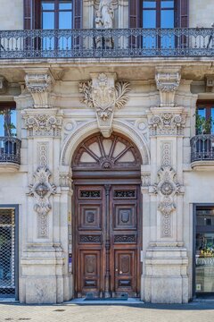 Wooden Entrance Door with Carved Stone Facade, Ornate Historical Classical Architectural Details, Arched Portal