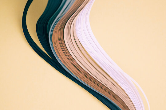 Close-up of quilling papers on beige background