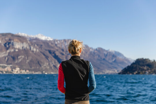 Italy, Como, rear view of woman enjoying the view of Lake Como