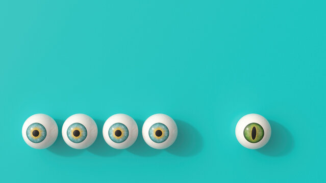 A unique green cat eyeball contrasts with a blue human eyeball row