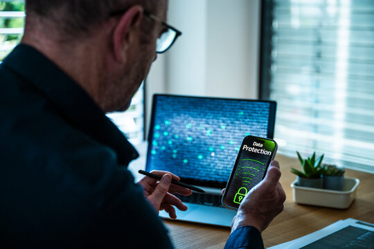 Man holds smartphone with data protection screen in the office