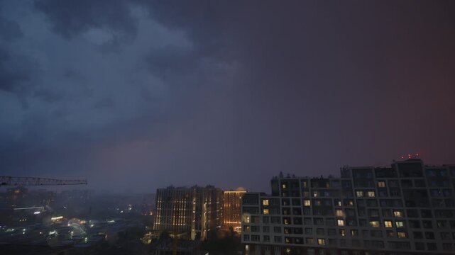 Timelapse of the stormy clouds with rain running over the city.