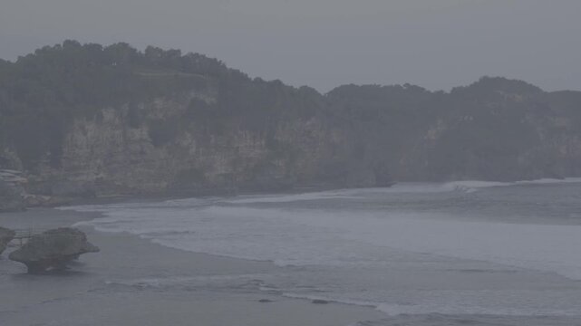 View of the sea cliffs, with waves crashing repeatedly, High rocky cliffs stretching from end to end. Panoramic View, S-Log3, S-Gamut3.Cine