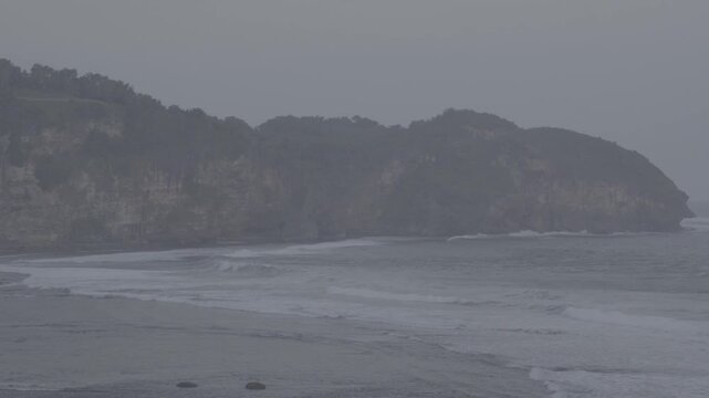 View of the sea cliffs, with waves crashing repeatedly, High rocky cliffs stretching from end to end. Panoramic View, S-Log3, S-Gamut3.Cine