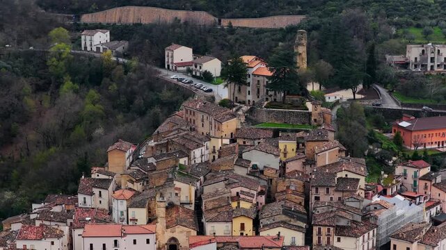 Aerial view of the historic stone buildings and terracotta rooftops of the medieval village of Anversa degli Abruzzi, Abruzzo, Italy.