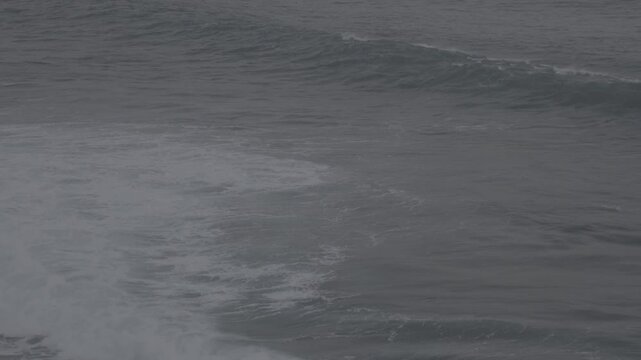 Large waves rolled in the middle of the sea, with white foam visible. Elevated view, S-Log3, S-Gamut3.Cine