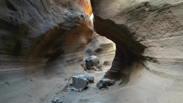 Stunning interior view of the Barranco de las Vacas ravine. Smooth, curved walls of volcanic tuff sculpted by water erosion in Gran Canaria