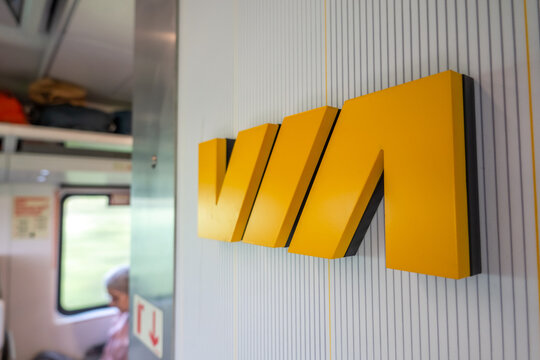 Montreal, Quebec, Canada. July 28, 2026. Close up view of yellow VIA Rail logo on wall inside passenger train car.