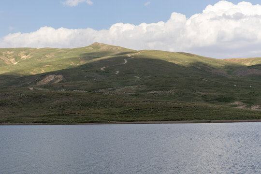 Tekir Pond at Erciyes Mountain Ski Resort with Snowy Landscape and Blue Sky. Scenic view of Tekir Pond located at the base of Erciyes Mountain near the ski resort in Kayseri, Turkey. 