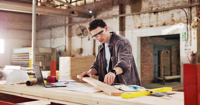 Engineer, carpenter and man with plank in workshop for project, planning and manufacture furniture. Warehouse, measurement and woodworker with equipment, timber material and small business in factory