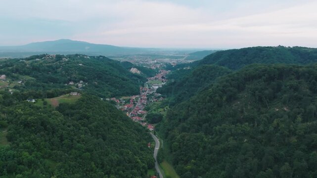 Aerial view of the town of Samobor nestled in a lush green valley with rolling hills and a winding road in Samobor, Zagrebacka zupanija, Croatia.