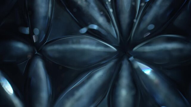 Macro view of blue cut crystal forming a floral pattern with bright reflections. Concept luxury, design, branding, wallpaper, advertising, art, and background use.