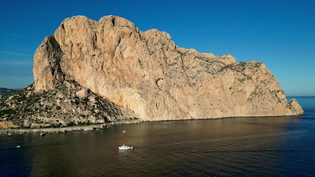 Aerial view of the massive Penyal d'Ifac limestone rock formation rising above the Mediterranean Sea in Calp, Valencian Community, Spain.