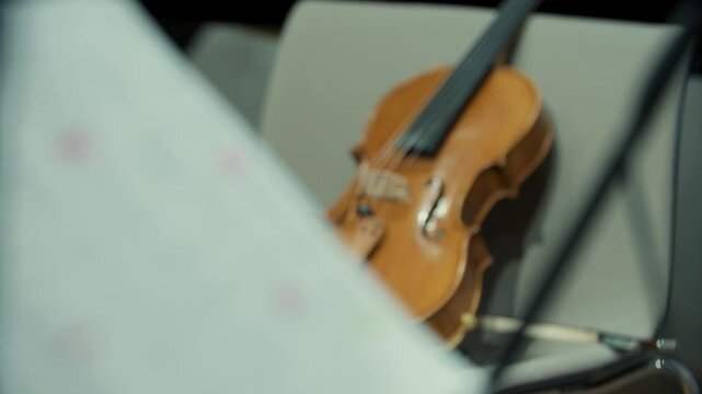 Sheet with notes and a violin in the background, focus shift, music, 4k