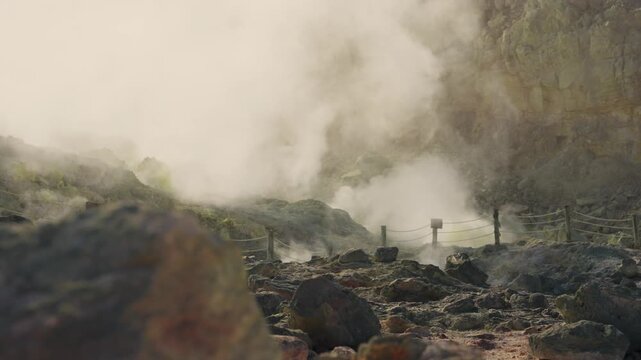 Scenic view of sulfurous steam and volcanic gases rising from fumaroles at Mount Io in Hokkaido's Akan Mashu National Park. Powerful geothermal activity of region on sunny day outdoors