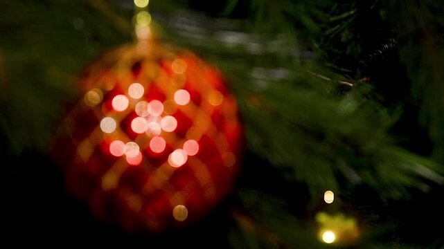 A Christmas tree decorated with various toys, garlands and lights hanging from its branches.