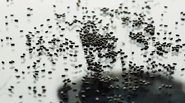 Falling chia seeds forming a pile. Close up of vegan food