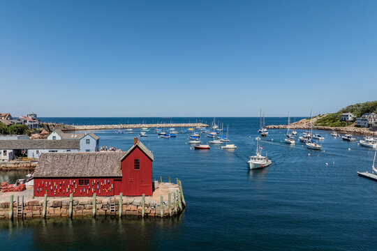 Aerial view of Motif Number 1, the iconic red fishing shack, surrounded by sailboats in the harbor of Rockport, Massachusetts, United States.
