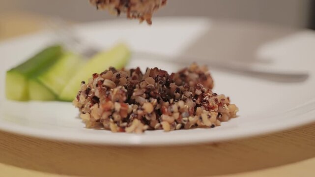 Wholesome grain blend with quinoa served onto plate, promoting healthy eating