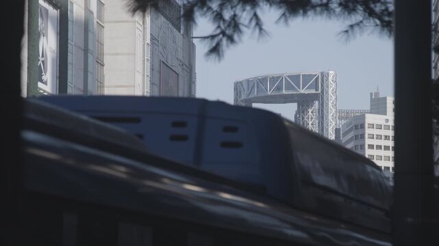 A Blue Bus Passes by with Jongno Tower in the Distance