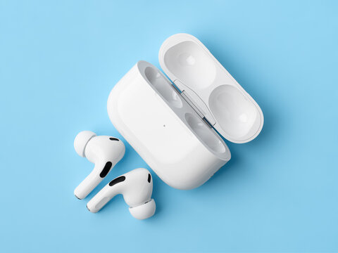 Dnipro, UKRAINE 29.04.2025: Apple AirPods Pro with an open wireless charging case on a bright. High-quality wireless Bluetooth earbuds, iconic consumer electronics product.