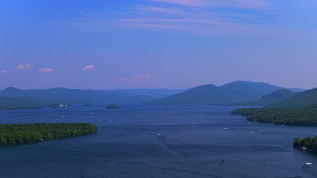 Islands of Lake George New York State aerial drone view nature landscape spring summer July sunny boating swimming recreation water activities morning blue sky Adirondack Mountains circle right motion