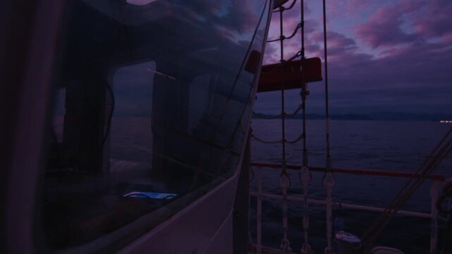 Sailing boat sails in the sea at twilight. Details of the sailing boat