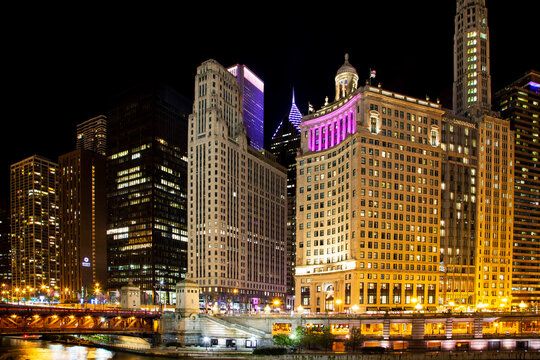 Chicago, Illinois, USA, October 1, 2024 - The Hyatt Regency Chicago, the London House and other buildings on Wacker Drive along the river seen illuminated at night 