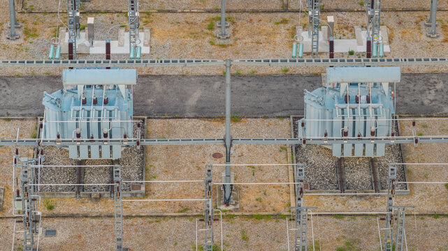 Aerial view of high-voltage electrical transformers and switching equipment inside a modern power substation in Valence, Auvergne-Rhone-Alpes, France.