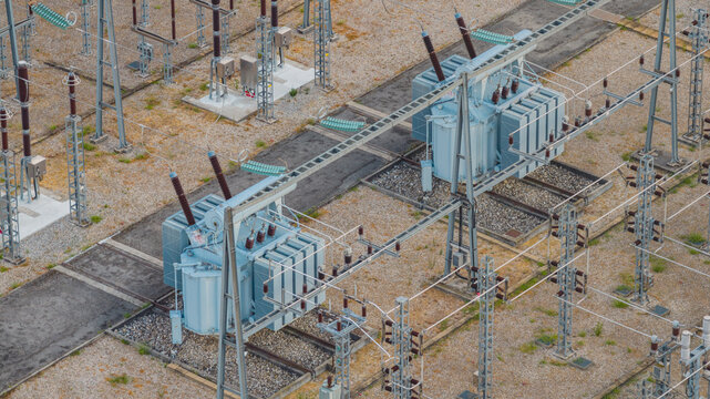 Aerial view of high-voltage electrical transformers and switching equipment inside a modern power substation in Valence, Auvergne-Rhone-Alpes, France.
