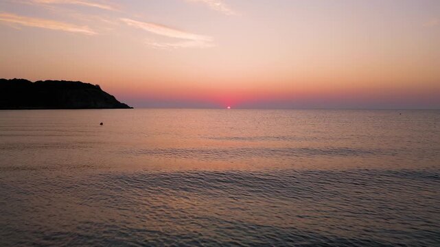 Drone Flying Forward Over Sea Water Towards Scenic Sunrise Sunset