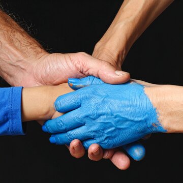 Blue Gloved Hands Grasping Hands in Strong Grip