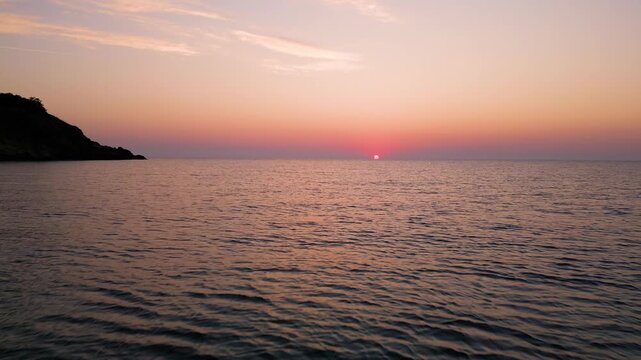 Drone Flying Forward Over Sea Water Towards Scenic Sunrise Sunset