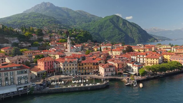 Aerial view of Menaggio town on Lake Como with historic buildings and mountains, picturesque waterfront cityscape in Italy. Menaggio coastal village on Lake Como before sunset