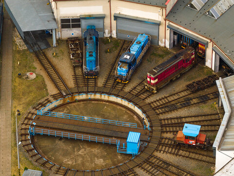 Aerial view of a railway turntable with several locomotives parked in a depot area in Breclav, South Moravian Region, Czechia.