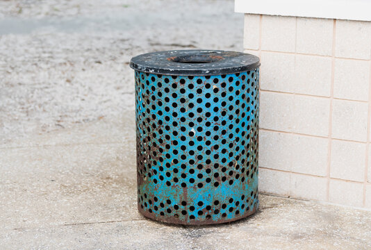Rubbish bin by a wall