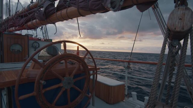 Expeditional sailing vessel moves in the Atlantic Ocean during sunrise