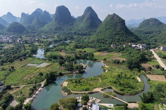 Aerial view of the karst mountains and winding river in the rural landscape of Yangshuo County, Guilin, Guangxi, China.