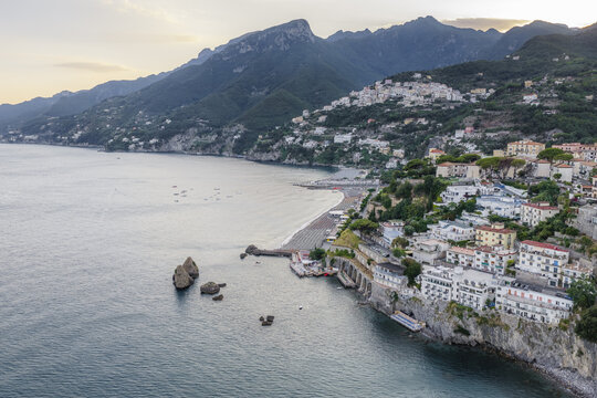 Aerial view of the coastal town of Vietri sul Mare with colorful buildings perched on cliffs overlooking the Mediterranean Sea and sandy beach in Vietri sul Mare, Salerno, Campania, Italy.