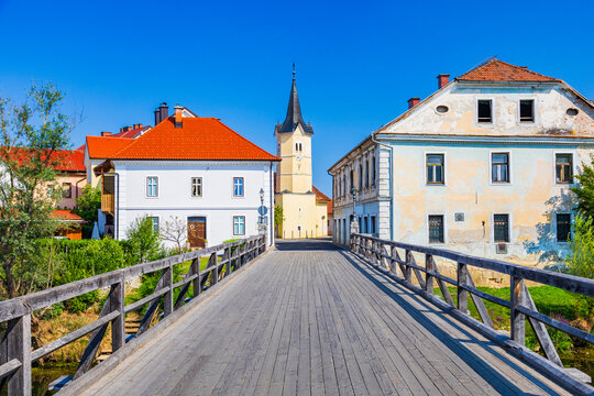 Old wooden bridge over Krka river in town Kostanjevica na Krki in Slovenia.