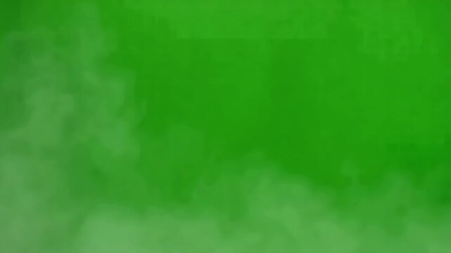 Wispy smoke plumes drift across a vibrant green background during a slow atmospheric reveal